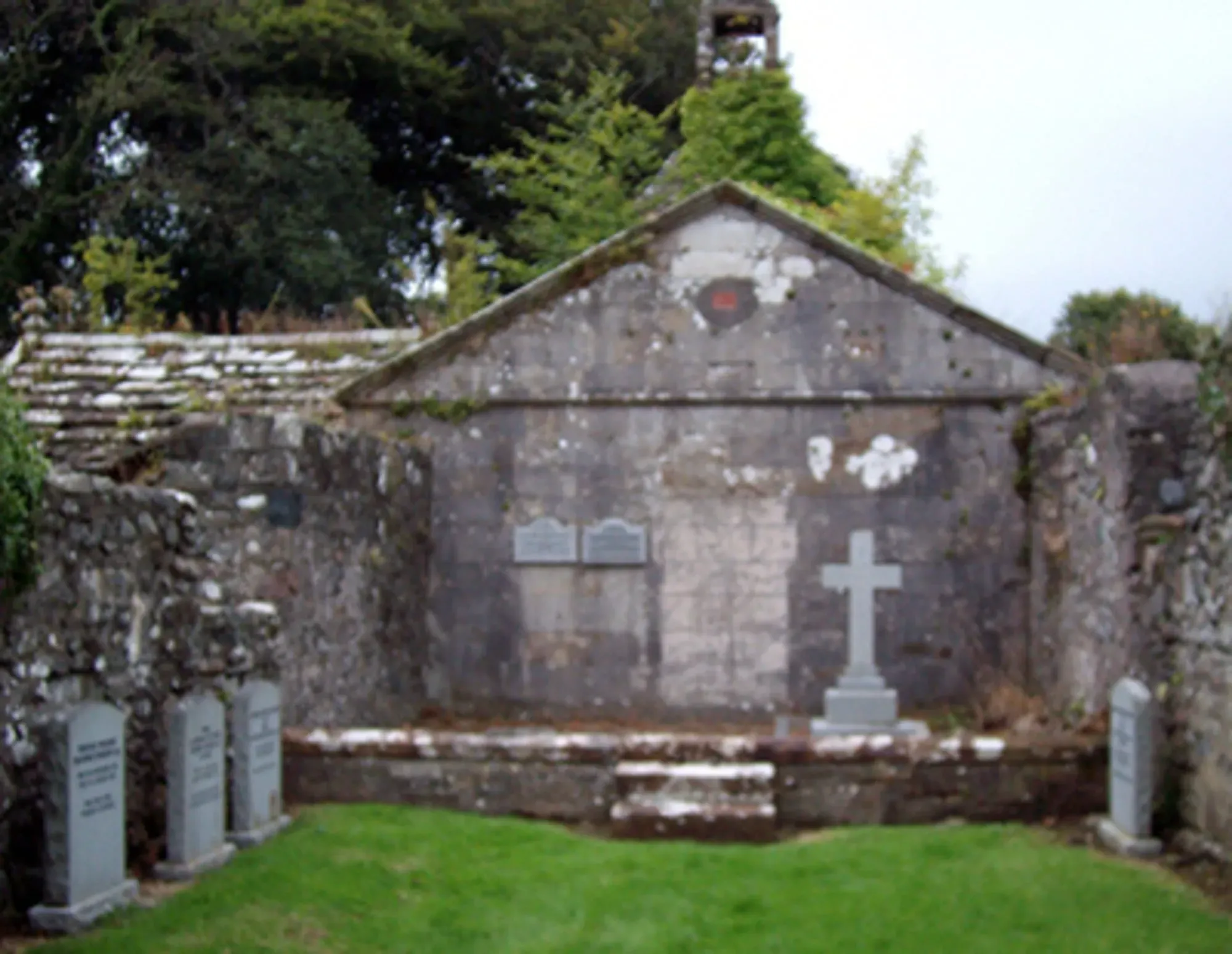 Ruined chapel with modern gravestones.   Photograph: Mike Bailey